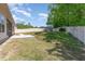Landscaped backyard with privacy fence and a storage shed at 49 Parkside Dr, Lillington, NC 27546