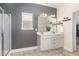 Modern bathroom features a double sink vanity, framed mirror, and walk-in shower at 49 Parkside Dr, Lillington, NC 27546