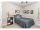 Cozy bedroom with carpet, neutral walls, and decorative artwork above the bed at 49 Parkside Dr, Lillington, NC 27546