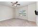 Spacious bedroom with large window, plush carpet, and ceiling fan at 49 Parkside Dr, Lillington, NC 27546