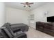Comfortable bedroom with carpeted floors, ceiling fan, and plenty of natural light at 49 Parkside Dr, Lillington, NC 27546