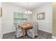 Cozy dining room with wood table, decorative chairs, chandelier, and natural light at 49 Parkside Dr, Lillington, NC 27546