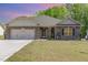 Charming brick home with a well-manicured lawn and an attached two-car garage at 49 Parkside Dr, Lillington, NC 27546