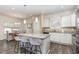 Modern kitchen features an island with seating, granite countertops, and stainless steel appliances at 49 Parkside Dr, Lillington, NC 27546