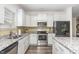 Well-equipped kitchen boasts stainless steel appliances, granite countertops, and ample cabinet space at 49 Parkside Dr, Lillington, NC 27546