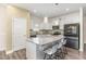 Bright kitchen with granite counters, center island, and stainless-steel appliances at 49 Parkside Dr, Lillington, NC 27546