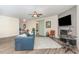 Comfortable living area boasts a fireplace, ceiling fan, and access to the dining area at 49 Parkside Dr, Lillington, NC 27546