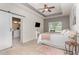 Serene main bedroom features a tray ceiling, ceiling fan, and ensuite bathroom at 49 Parkside Dr, Lillington, NC 27546