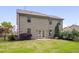View of the back exterior of the home, showing the well-manicured lawn and lush landscaping at 504 Applecross Dr, Mebane, NC 27302