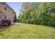 Expansive backyard with a lush lawn and mature trees, offering privacy and space for outdoor activities at 504 Applecross Dr, Mebane, NC 27302
