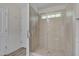 Bright bathroom featuring a glass-enclosed tiled shower with a built-in window at 504 Applecross Dr, Mebane, NC 27302