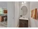 Cozy bathroom with an oval mirror and dark wood cabinet at 504 Applecross Dr, Mebane, NC 27302