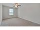 Bedroom features neutral carpet, light walls, a ceiling fan, and a window at 504 Applecross Dr, Mebane, NC 27302