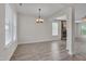 Bright dining room featuring vinyl plank flooring and a modern chandelier at 504 Applecross Dr, Mebane, NC 27302