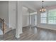 Open floor plan with dining area, stairs, and large windows for natural light at 504 Applecross Dr, Mebane, NC 27302