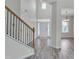 Bright foyer featuring vinyl plank flooring and stairs leading to upper level at 504 Applecross Dr, Mebane, NC 27302