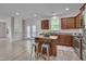 Bright kitchen featuring stainless steel appliances, a central island, and dark cabinets at 504 Applecross Dr, Mebane, NC 27302