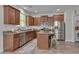 Well-equipped kitchen features stainless steel appliances, granite countertops, and wood cabinets at 504 Applecross Dr, Mebane, NC 27302