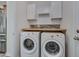Bright laundry room features updated appliances, storage cabinets, and a butcher block folding table at 504 Applecross Dr, Mebane, NC 27302