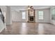 Spacious living room featuring a cozy stone fireplace and large windows at 504 Applecross Dr, Mebane, NC 27302