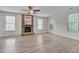 Spacious living room with modern ceiling fan and stone fireplace at 504 Applecross Dr, Mebane, NC 27302