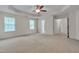 Spacious main bedroom featuring a tray ceiling, fan, and an ensuite bathroom entrance at 504 Applecross Dr, Mebane, NC 27302