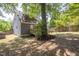 Spacious backyard with a wood deck, large tree, and partial fence at 507 Canal St, Durham, NC 27701