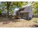 Large backyard with a wood deck, stone patio, and mature tree providing plenty of shade at 507 Canal St, Durham, NC 27701
