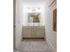 Bathroom features a double sink vanity with a large mirror and neutral tiling on the floor at 507 Canal St, Durham, NC 27701