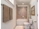 Stylish bathroom features neutral tiling in shower, and bright natural light at 507 Canal St, Durham, NC 27701