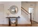 Bright entryway features hardwood floors, staircase, wooden console table, and stylish circular mirror at 507 Canal St, Durham, NC 27701