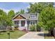 Charming home featuring a cozy front porch and beautiful landscaping, complete with a driveway and manicured lawn at 507 Canal St, Durham, NC 27701