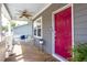 Charming front porch with a swing, ceiling fan, and bright red front door at 507 Canal St, Durham, NC 27701