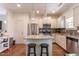 Modern kitchen with stainless steel appliances, granite countertops and gray tile backsplash at 507 Canal St, Durham, NC 27701