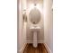 Powder room with pedestal sink and decorative mirror at 507 Canal St, Durham, NC 27701