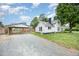 Quaint home with gravel driveway and covered parking at 510 May St, Gibsonville, NC 27249