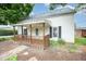 Charming home featuring a covered front porch with decorative wood railing at 510 May St, Gibsonville, NC 27249