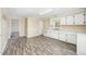 Spacious kitchen featuring white cabinetry and a modern vinyl floor at 510 May St, Gibsonville, NC 27249