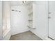 This mudroom has storage shelves and concrete floors at 510 May St, Gibsonville, NC 27249