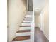Hallway with painted stairway and carpeted floor at 510 May St, Gibsonville, NC 27249