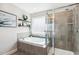 Elegant bathroom featuring a soaking tub, glass shower, and contemporary fixtures at 5172 Copain Cove, Fuquay Varina, NC 27526