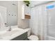 Bathroom with white cabinet, vanity with marble countertop, and a tub with white ruffle shower curtain at 5172 Copain Cove, Fuquay Varina, NC 27526