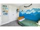 Bedroom featuring a twin bed with an accent wall mural of blue mountains and storage shelves at 5172 Copain Cove, Fuquay Varina, NC 27526