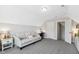 Bonus room with a comfortable sofa, desk area, built-in shelving, and a doorway leading to stairs at 5172 Copain Cove, Fuquay Varina, NC 27526