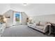Bonus room with a comfortable sofa, built-in shelving, and a bright window with backyard views at 5172 Copain Cove, Fuquay Varina, NC 27526