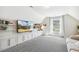 Bonus room with a large tv, built-in shelving, and a bright window with neighborhood views at 5172 Copain Cove, Fuquay Varina, NC 27526
