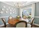 Bright dining room with large window and chandelier, perfect for entertaining at 5172 Copain Cove, Fuquay Varina, NC 27526