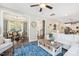 Bright and airy living room with view to dining room and kitchen; hardwood floors and large area rug at 5172 Copain Cove, Fuquay Varina, NC 27526