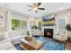 Inviting living room featuring a fireplace, large windows, and comfortable seating at 5172 Copain Cove, Fuquay Varina, NC 27526