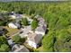 This aerial view showcases suburban homes surrounded by lush trees in a well-maintained neighborhood at 5240 Holly Ridge Farm Rd, Raleigh, NC 27616